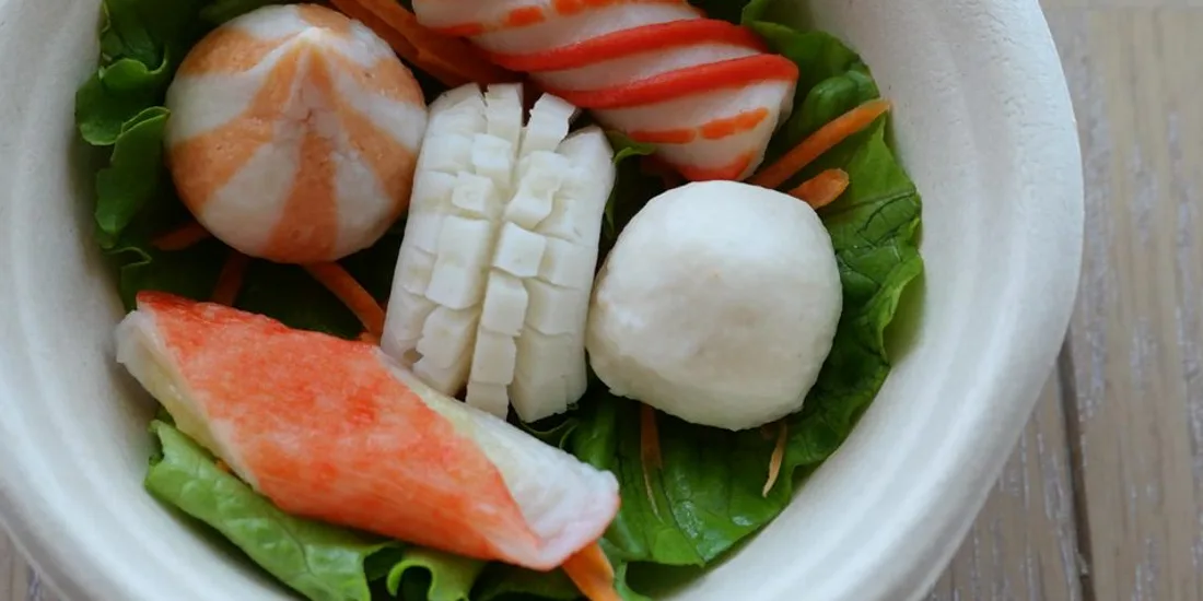 Crab stick, fish tofu and fish balls plated on lettuce.